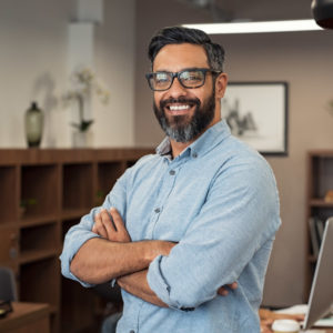 man in blue button up shirt smiling