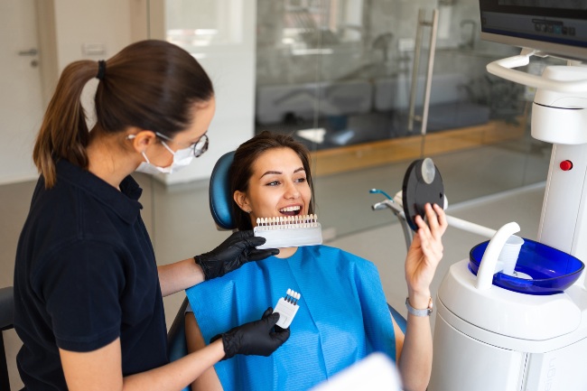 Patient getting dental veneers applied for a smile makeover at a clinic in Monett, MO.