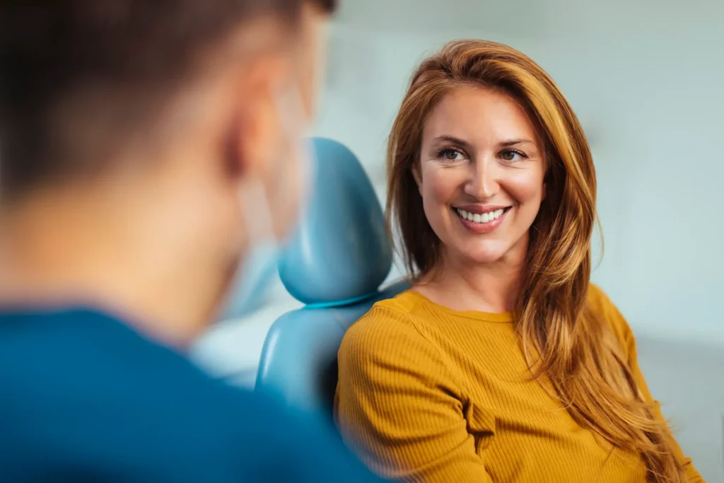 Patient smiling in a dental chair during a cosmetic dentistry consultation in Monett, MO