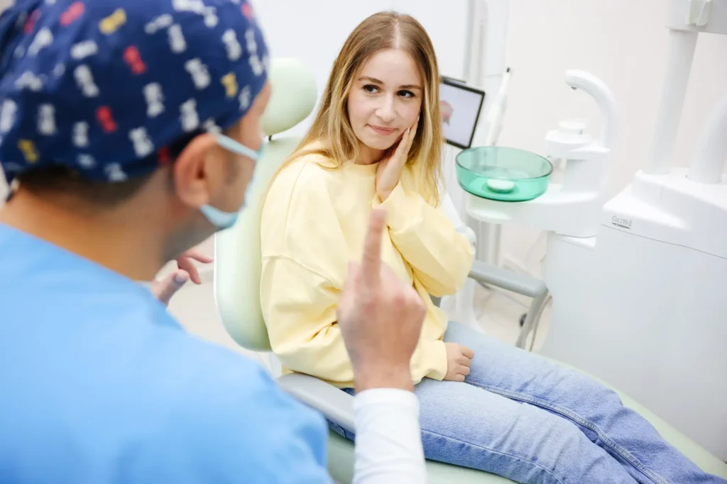 Patient experiencing dental pain during an emergency visit, consulting with a dentist in Monett, MO