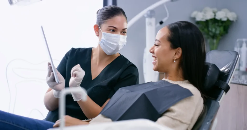 Dental professional discussing plaque buildup and oral hygiene with a patient in Monett, MO