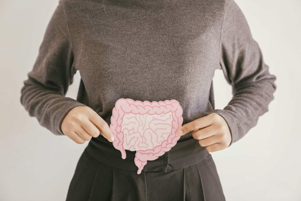 Visual representing connection between oral health and gut health using digestive system illustration in Monett, MO