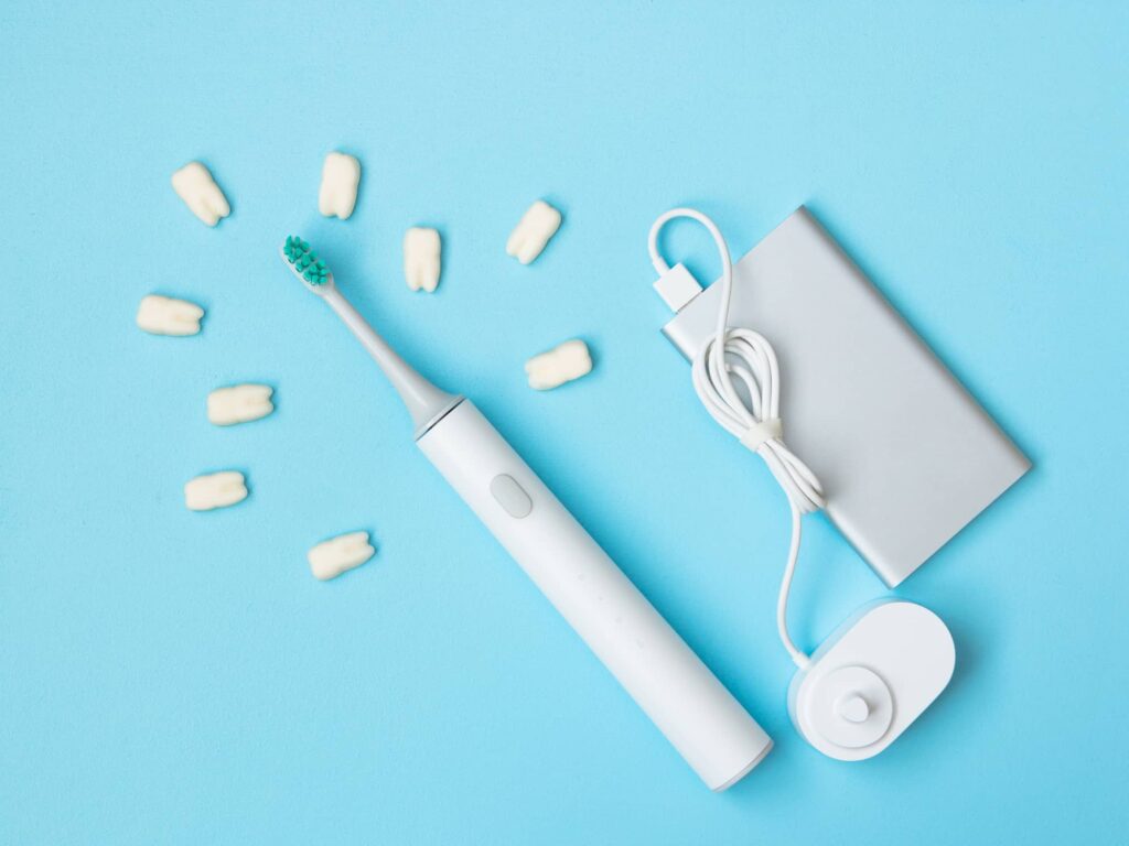 Smart electric toothbrush with charging base showing modern oral care technology in Monett, MO