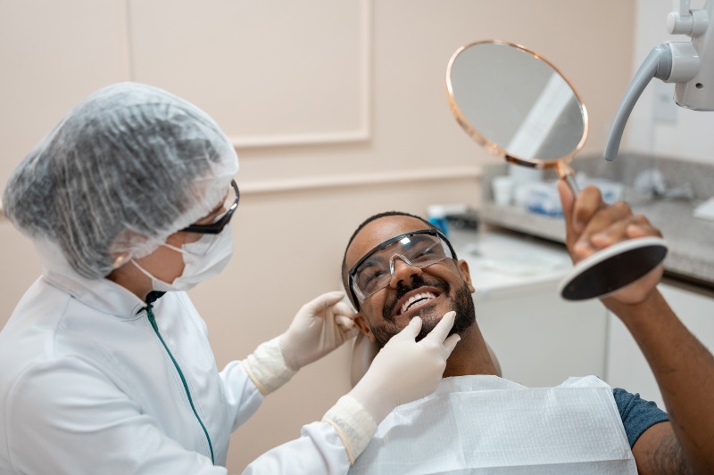 Patient viewing cosmetic dentistry results during a dental appointment in Monett, MO